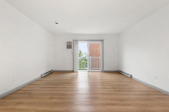 8 Lafayette Park Unit 9, Lynn, MA 01902 - spare room featuring a baseboard heating unit, light wood-style flooring, and a wall unit AC