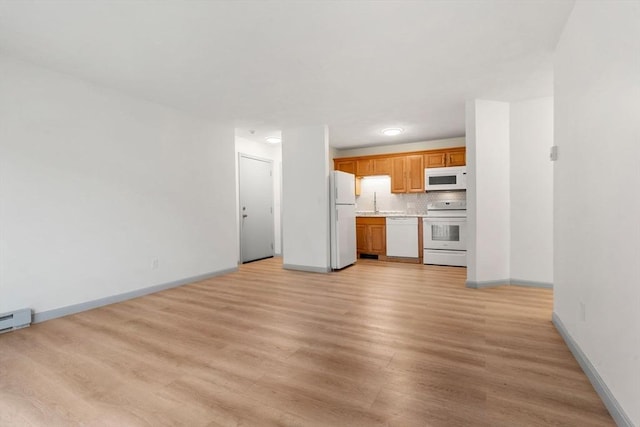 8 Lafayette Park Unit 9, Lynn, MA 01902 - kitchen with white appliances, light wood finished floors, light countertops, and backsplash