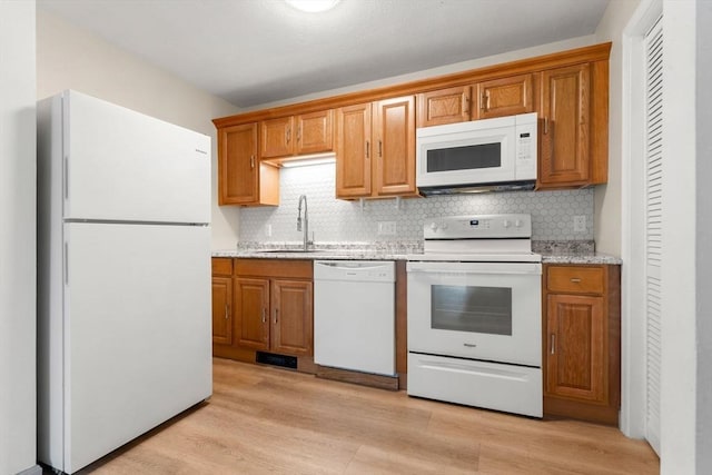 8 Lafayette Park Unit 9, Lynn, MA 01902 - kitchen with white appliances, tasteful backsplash, light wood-style flooring, and brown cabinetry