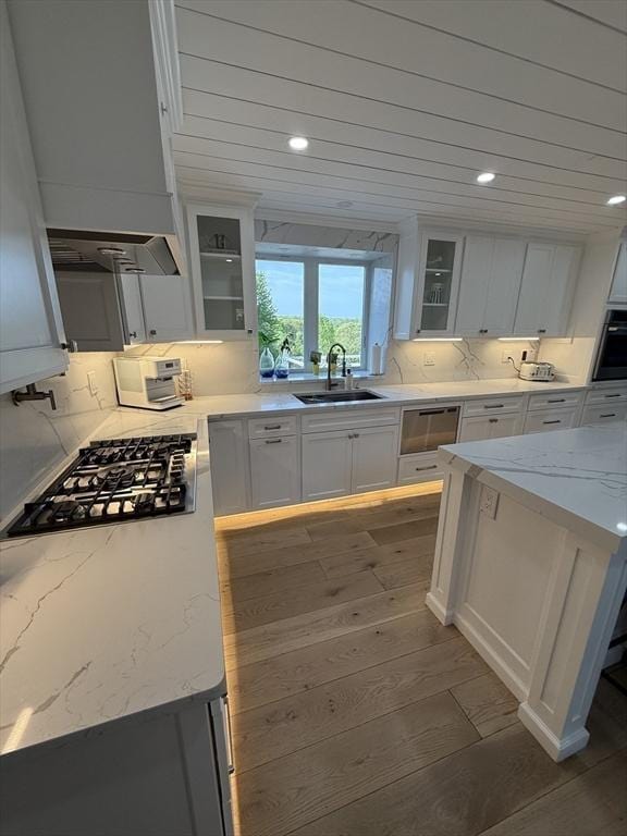 5 Cortland Dr, Hudson, MA 01749 - kitchen with a sink, custom exhaust hood, wood finished floors, appliances with stainless steel finishes, and white cabinetry