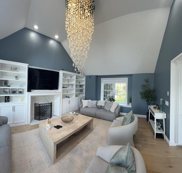 5 Cortland Dr, Hudson, MA 01749 - living area with lofted ceiling, light wood-style flooring, a fireplace, recessed lighting, and a chandelier