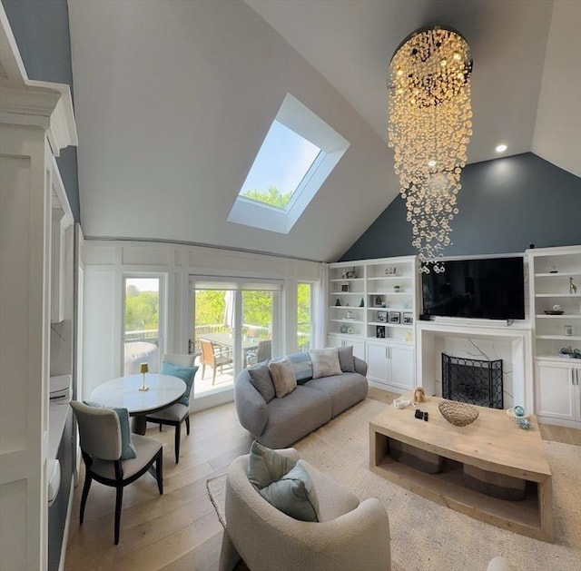 5 Cortland Dr, Hudson, MA 01749 - living area with a skylight, light wood-style flooring, a fireplace with raised hearth, high vaulted ceiling, and built in features