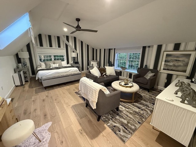 5 Cortland Dr, Hudson, MA 01749 - bedroom with wallpapered walls, light wood-style flooring, vaulted ceiling, ceiling fan, and a skylight
