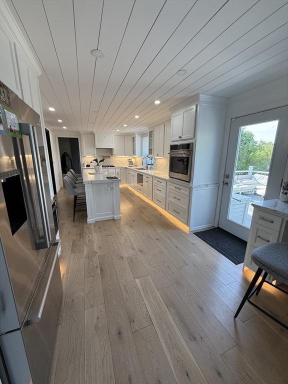 5 Cortland Dr, Hudson, MA 01749 - kitchen with stainless steel appliances, light wood finished floors, white cabinets, light countertops, and recessed lighting