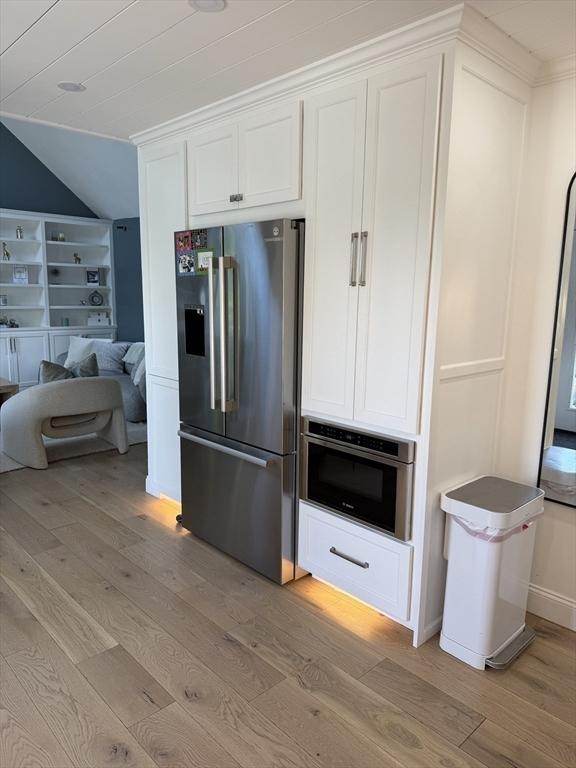 5 Cortland Dr, Hudson, MA 01749 - kitchen with appliances with stainless steel finishes, light wood-style flooring, lofted ceiling, and white cabinets