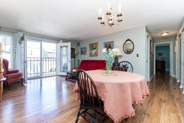 11 Church Unit 313, Salem, MA 01970 - dining space featuring a chandelier, wood finished floors, and baseboards