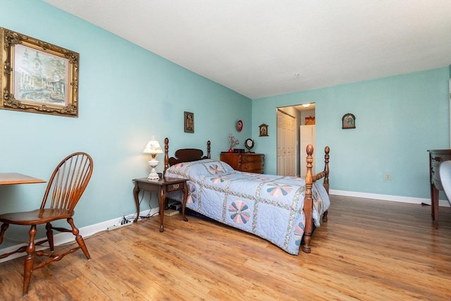 11 Church Unit 313, Salem, MA 01970 - bedroom with wood finished floors, baseboards, vaulted ceiling, and a closet