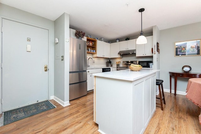 11 Church Unit 313, Salem, MA 01970 - kitchen featuring black appliances, under cabinet range hood, light countertops, and light wood finished floors