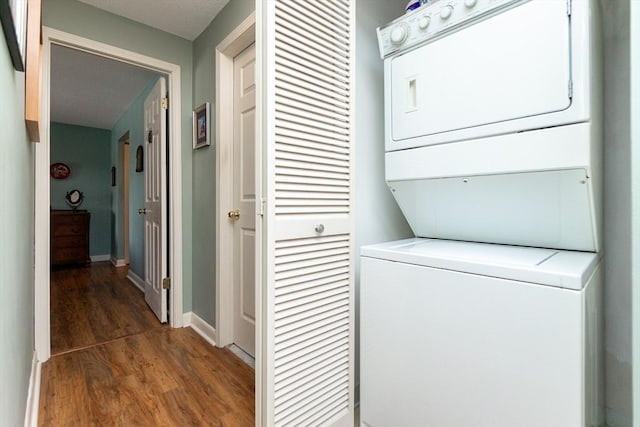 11 Church Unit 313, Salem, MA 01970 - washroom with stacked washer / dryer, wood finished floors, and baseboards
