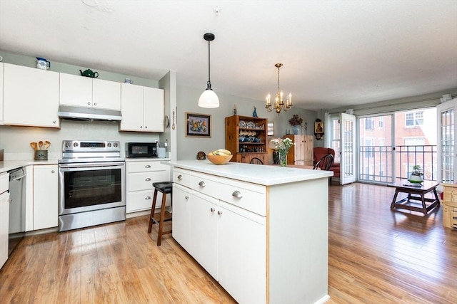 11 Church Unit 313, Salem, MA 01970 - kitchen featuring stainless steel appliances, under cabinet range hood, light wood-style flooring, a chandelier, and light countertops