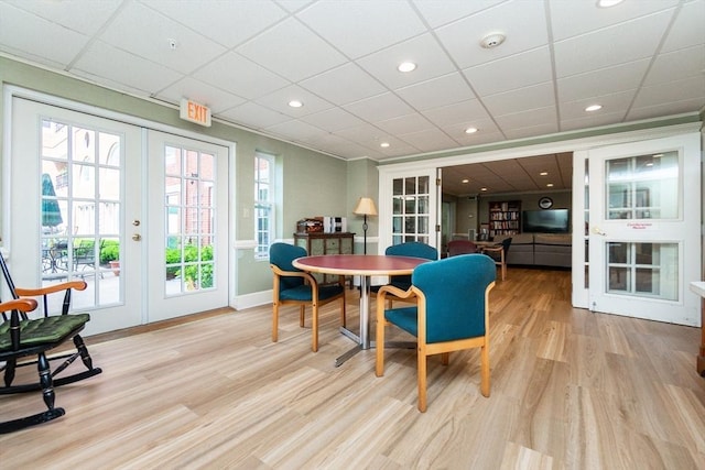 11 Church Unit 313, Salem, MA 01970 - dining room with french doors, light wood-style flooring, plenty of natural light, a drop ceiling, and baseboards
