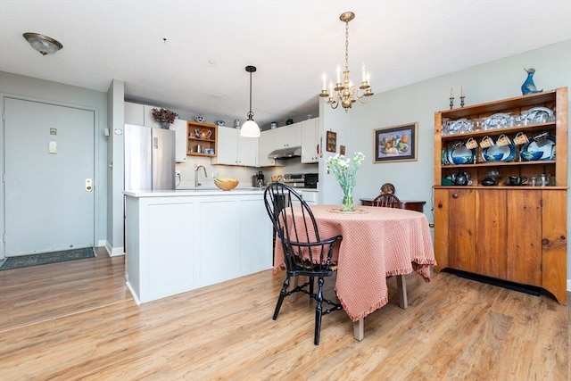 11 Church Unit 313, Salem, MA 01970 - dining area with a chandelier and light wood finished floors
