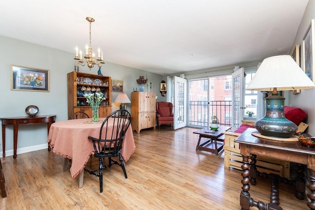 11 Church Unit 313, Salem, MA 01970 - dining area with a chandelier, wood finished floors, and baseboards