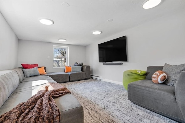 living room featuring a baseboard heating unit, baseboards, and carpet floors