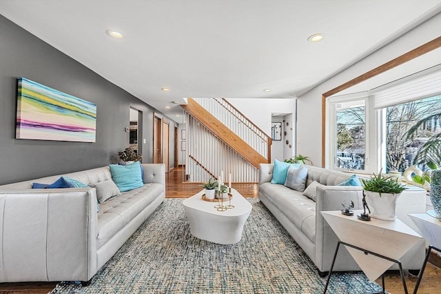 living room featuring recessed lighting, wood finished floors, and stairs