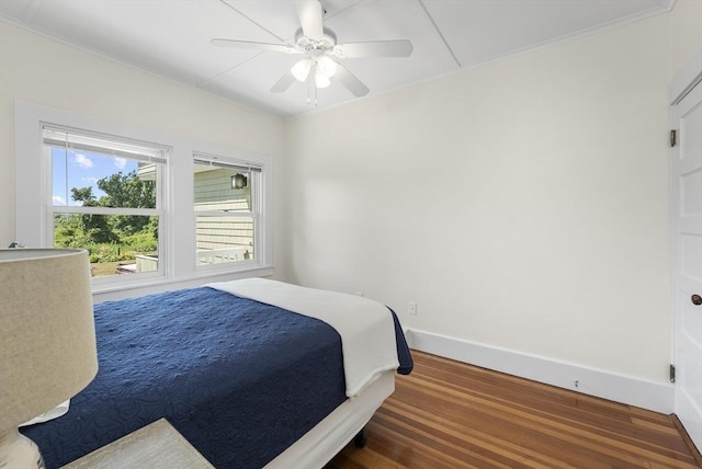 bedroom featuring dark hardwood / wood-style flooring and ceiling fan