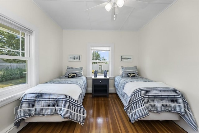 bedroom with multiple windows, dark wood-type flooring, and ceiling fan