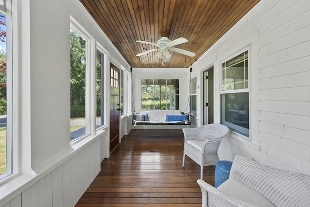 sunroom / solarium featuring ceiling fan and wood ceiling