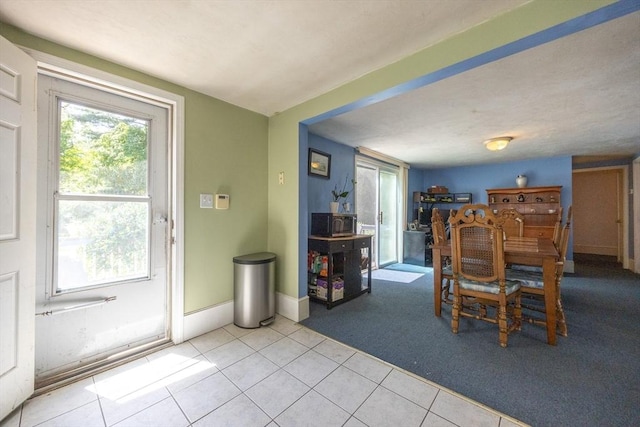 58 Howland St, Marlborough, MA 01752 - dining area with light tile patterned floors, light carpet, and baseboards