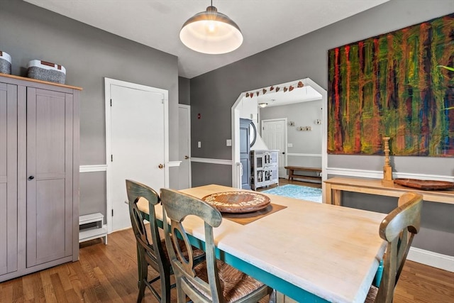 dining room with baseboards and wood finished floors