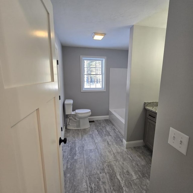 bathroom with vanity, toilet, and a bath