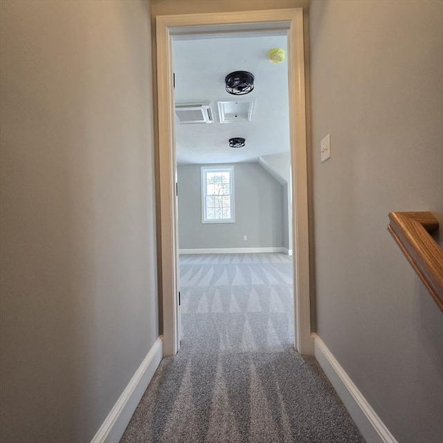 corridor featuring lofted ceiling and carpet floors