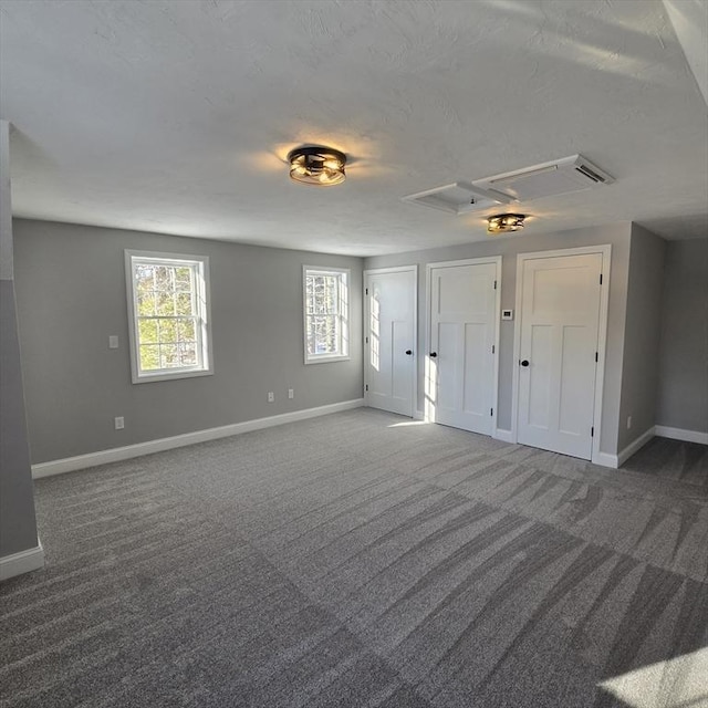 carpeted spare room featuring a textured ceiling