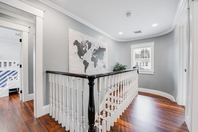 staircase with ornamental molding and hardwood / wood-style flooring