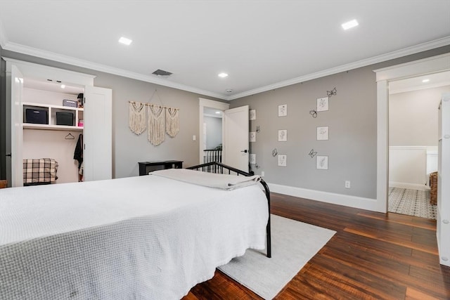 bedroom featuring a closet, dark hardwood / wood-style flooring, and crown molding