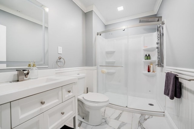 bathroom featuring an enclosed shower, vanity, crown molding, and toilet