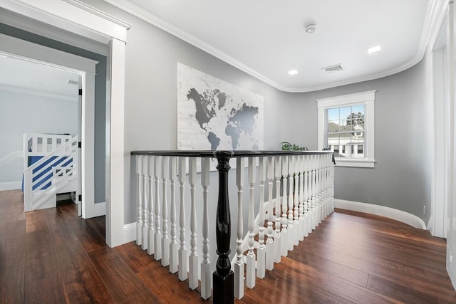 corridor featuring dark wood-type flooring and crown molding