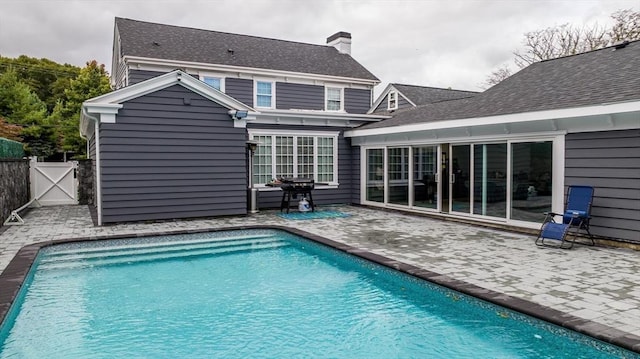 back of house featuring a patio area and a fenced in pool