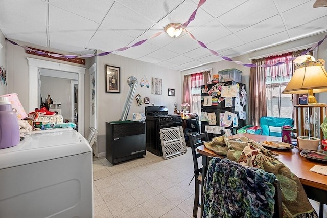 dining room featuring washer / dryer and a drop ceiling