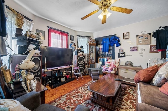 living room with wood finished floors and a ceiling fan