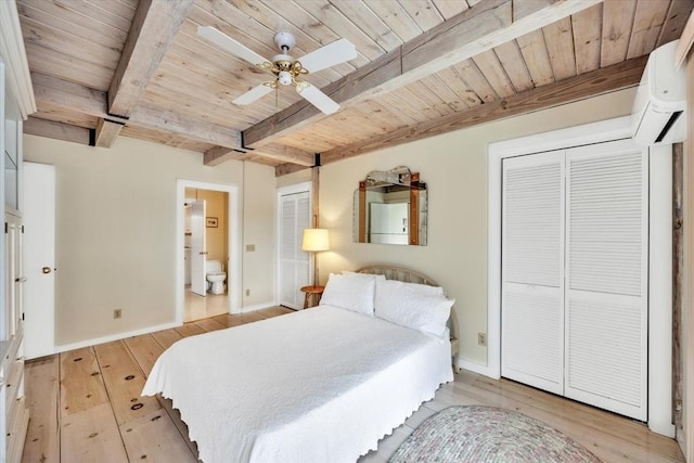 bedroom featuring beam ceiling, light wood-type flooring, two closets, and wood ceiling