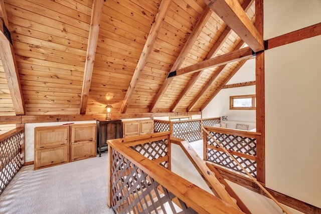 additional living space with vaulted ceiling with beams, light carpet, and wood ceiling