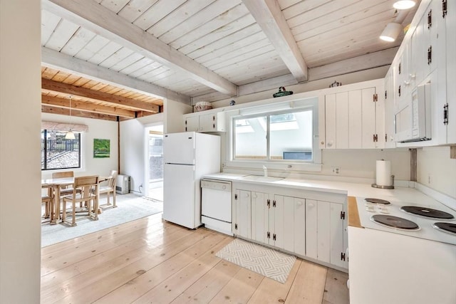 kitchen with white appliances, light wood-type flooring, wooden ceiling, light countertops, and a sink
