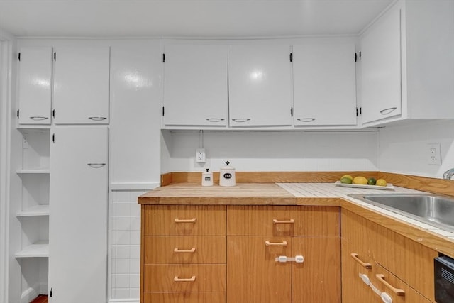 10 Shepard St Unit 2, Cambridge, MA 02139 - kitchen with light countertops, a sink, and white cabinets