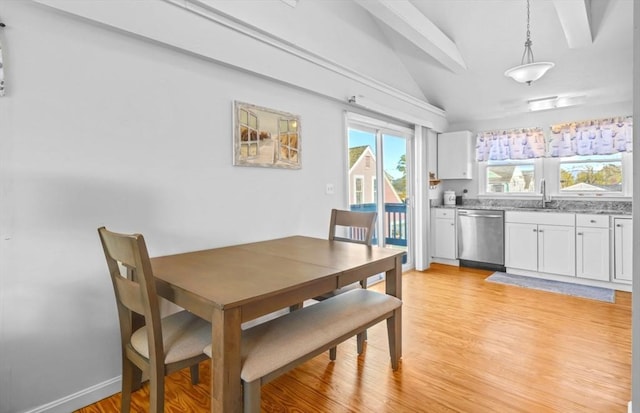 dining space featuring lofted ceiling and light wood-type flooring