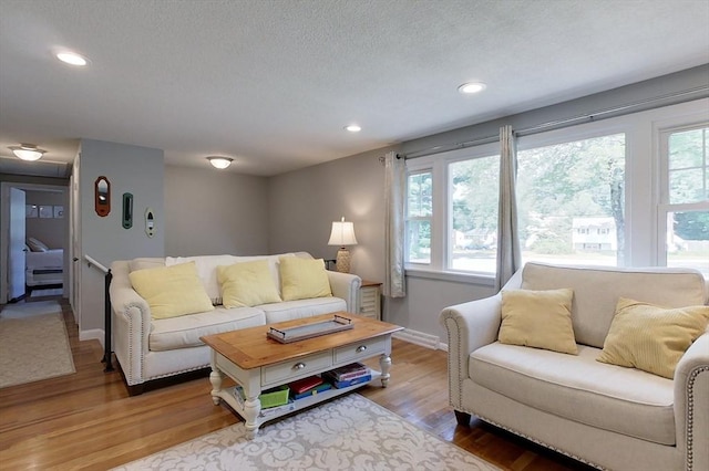 12 Pine St, Pepperell, MA 01463 - living area with wood finished floors, recessed lighting, and a textured ceiling
