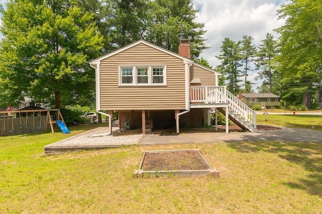 12 Pine St, Pepperell, MA 01463 - rear view of property with a chimney, a lawn, a playground, and a garden