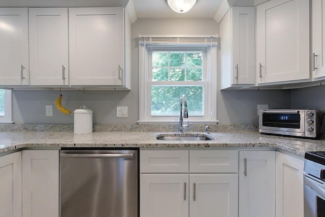 12 Pine St, Pepperell, MA 01463 - kitchen with stainless steel dishwasher, white cabinetry, and light stone countertops