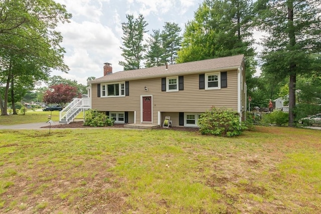 12 Pine St, Pepperell, MA 01463 - split foyer home with a chimney, a front lawn, and stairway