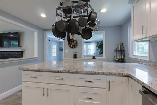 12 Pine St, Pepperell, MA 01463 - kitchen with stainless steel dishwasher, light stone countertops, white cabinetry, and recessed lighting