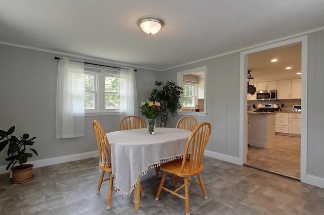 12 Pine St, Pepperell, MA 01463 - dining area with healthy amount of natural light, ornamental molding, a decorative wall, and stone finish flooring
