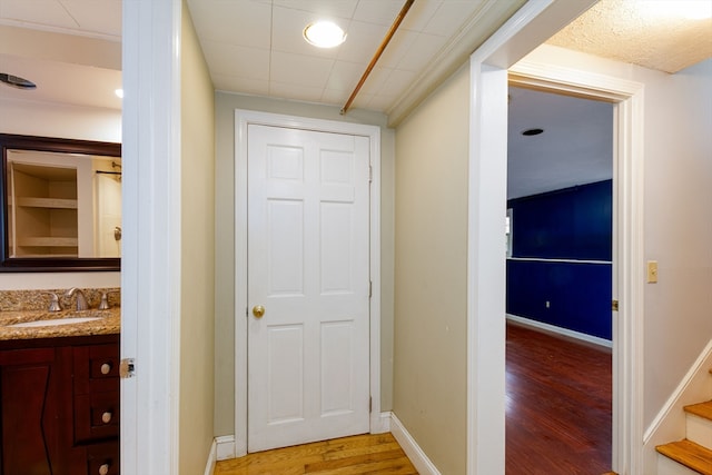 hallway featuring sink and wood-type flooring