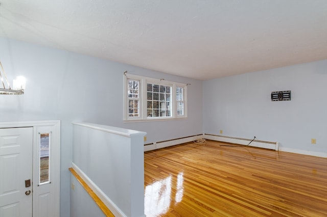 interior space featuring a baseboard radiator and hardwood / wood-style flooring