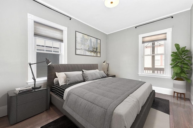 bedroom featuring crown molding and dark hardwood / wood-style flooring