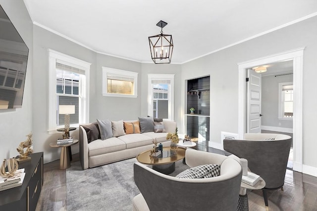 living room featuring crown molding, wood-type flooring, and an inviting chandelier