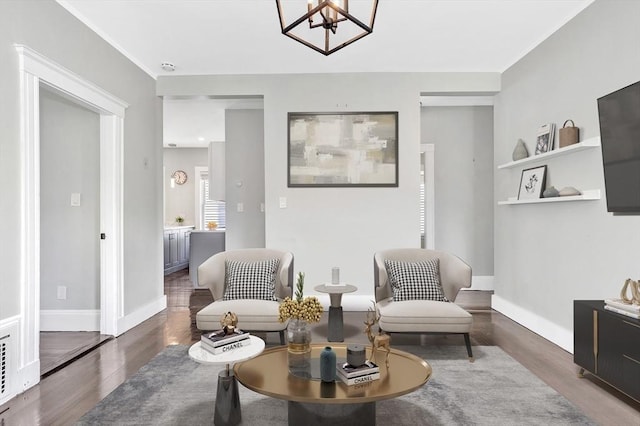 sitting room featuring a chandelier and dark hardwood / wood-style flooring